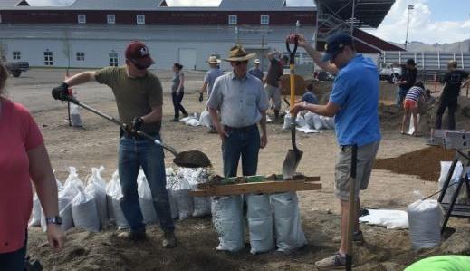 Volunteers help bag sand